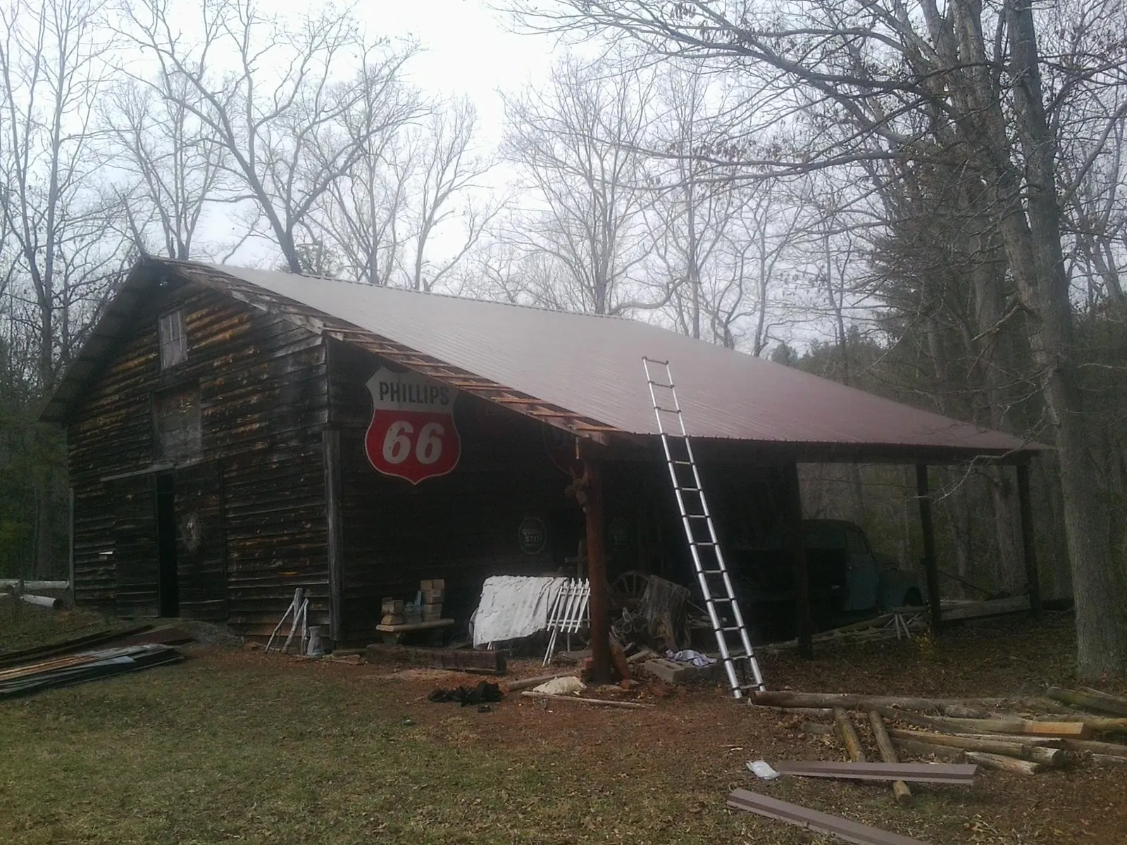 New metal roof on an open sided timber barn with a vintage sign in West Leyden